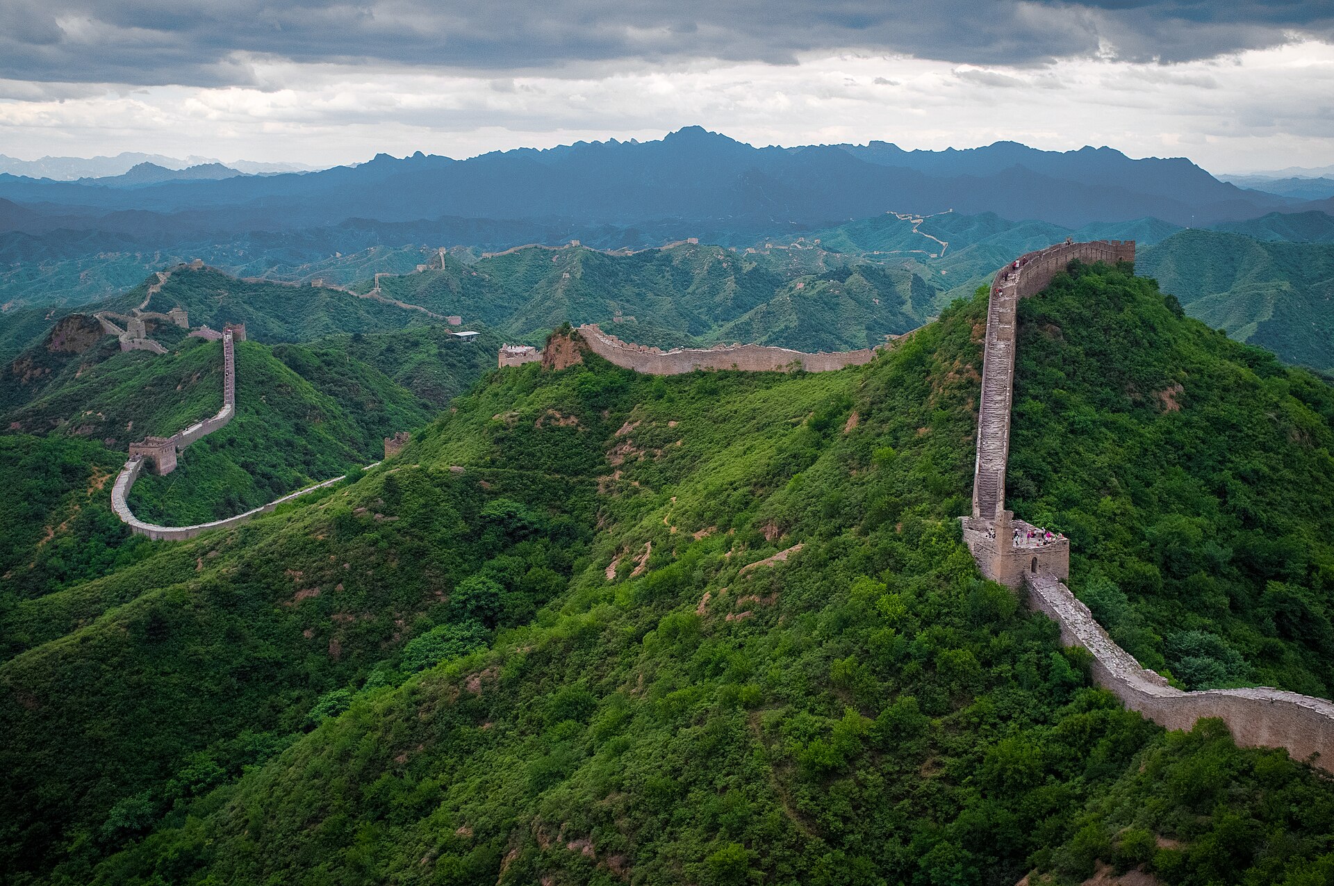 The Jinshanling section of the Great Wall winding along a green ridge with watchtowers and no crowds