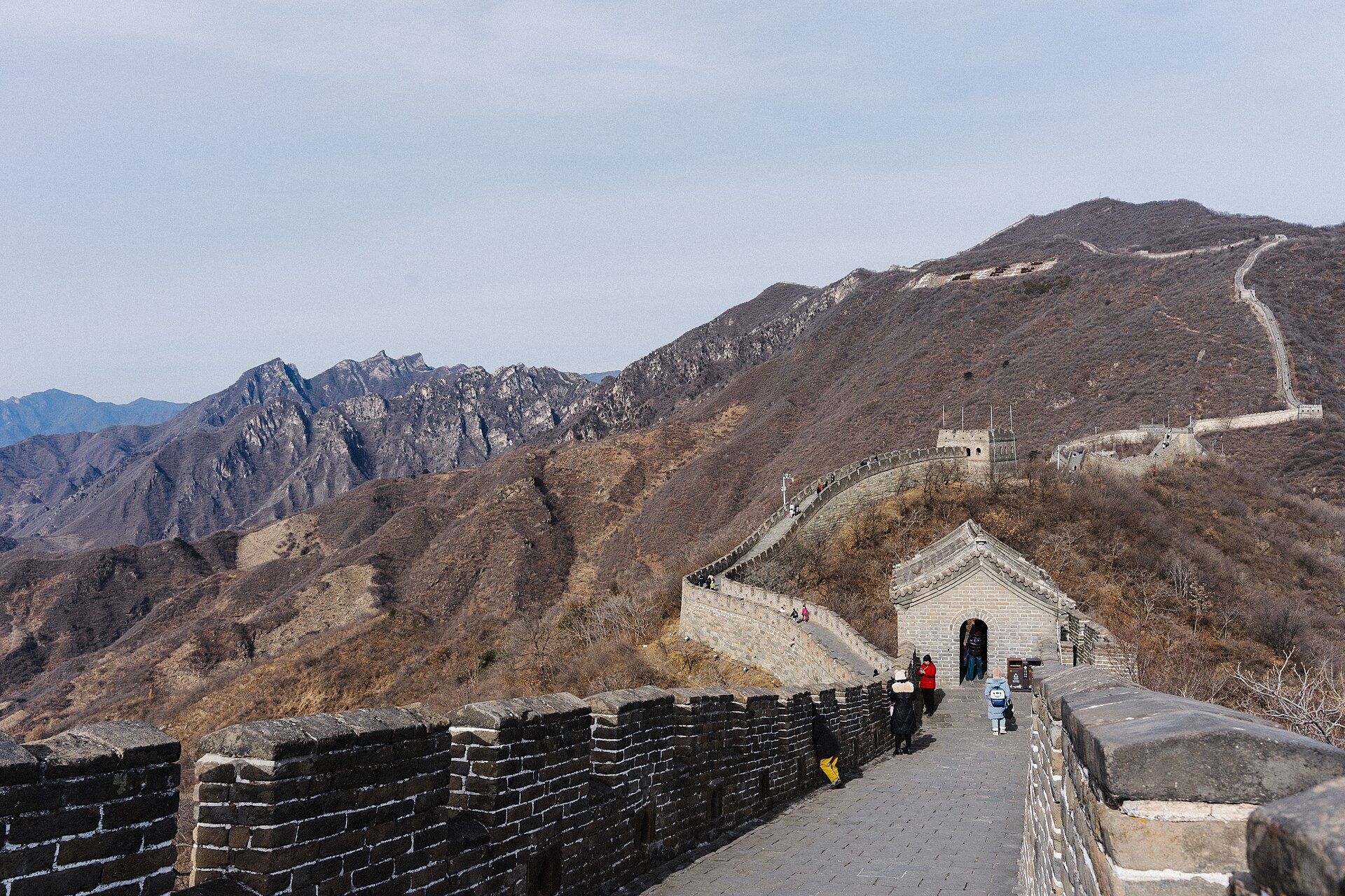 The restored Mutianyu section of the Great Wall with a smooth walkway, watchtowers and only a few visitors, mountains behind