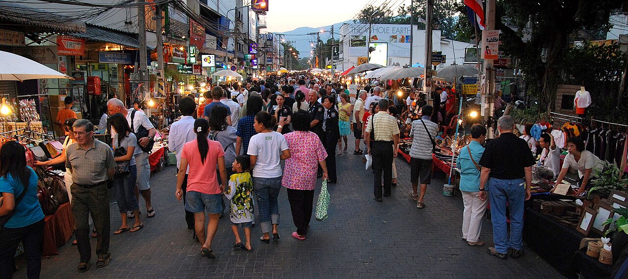 ถนนคนเดินวันอาทิตย์ เชียงใหม่ — ผู้คนเดินเลือกซื้อของตามแผงตลอดถนนราชดำเนินในเมืองเก่ายามเย็น