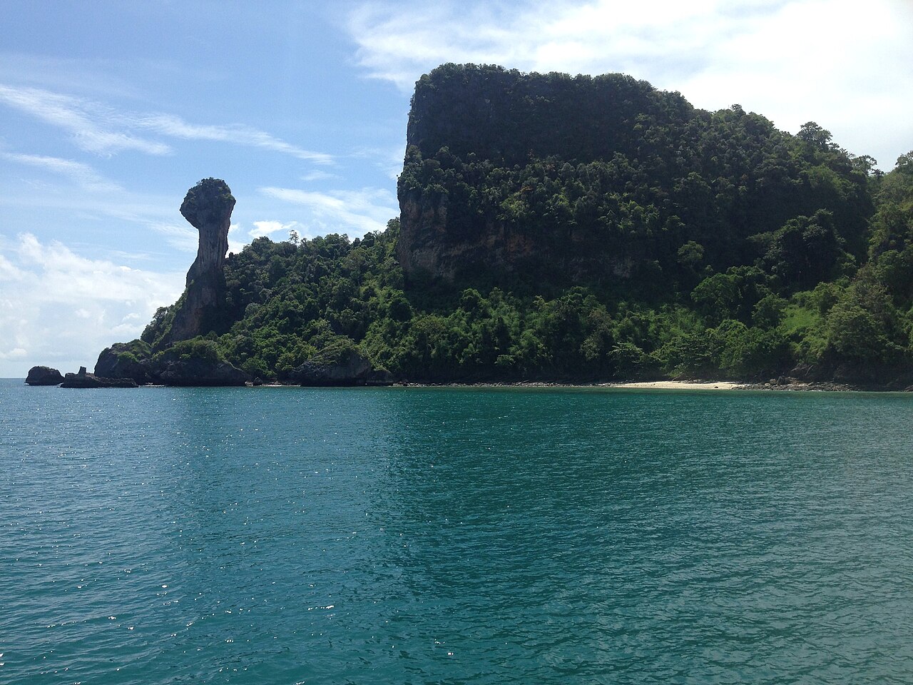 The Separated Sea Krabi — Chicken Island's chicken-head rock rising from turquoise sea, one of the islands the sandbar links at low tide