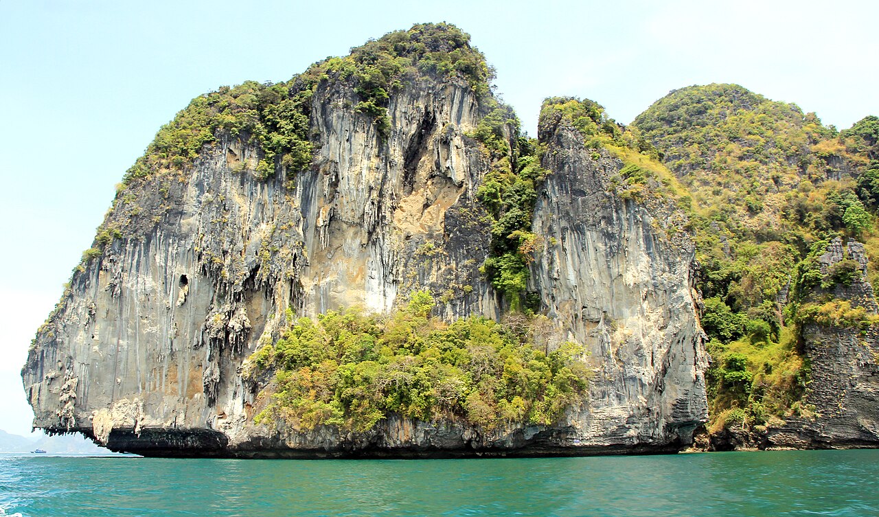 Krabi Four-Island tour — a steep limestone island rising out of jade-green sea, one of the islands on the Ao Nang day tour