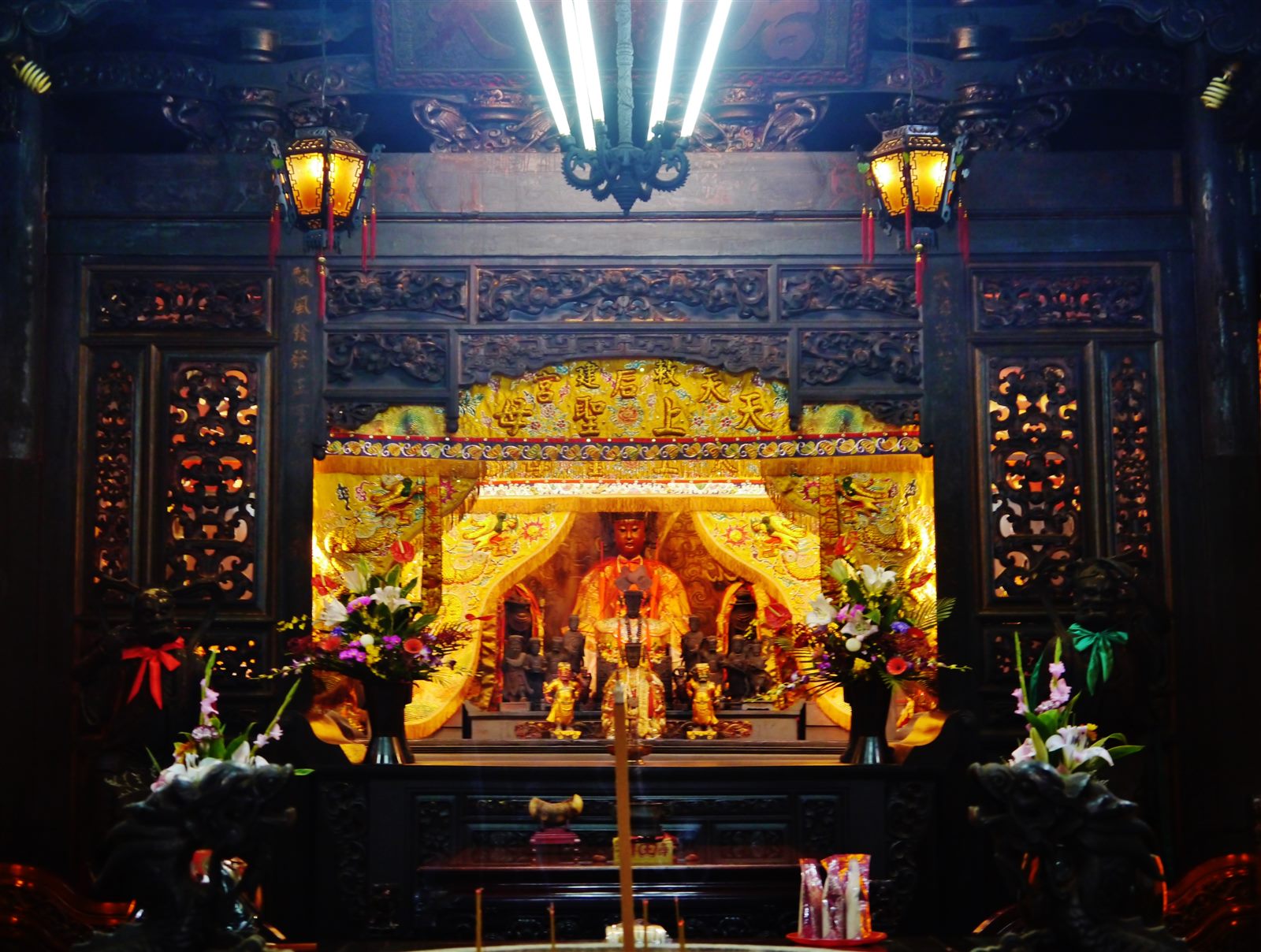 Interior of Lukang Mazu Temple with incense smoke, golden altar and warm amber lighting