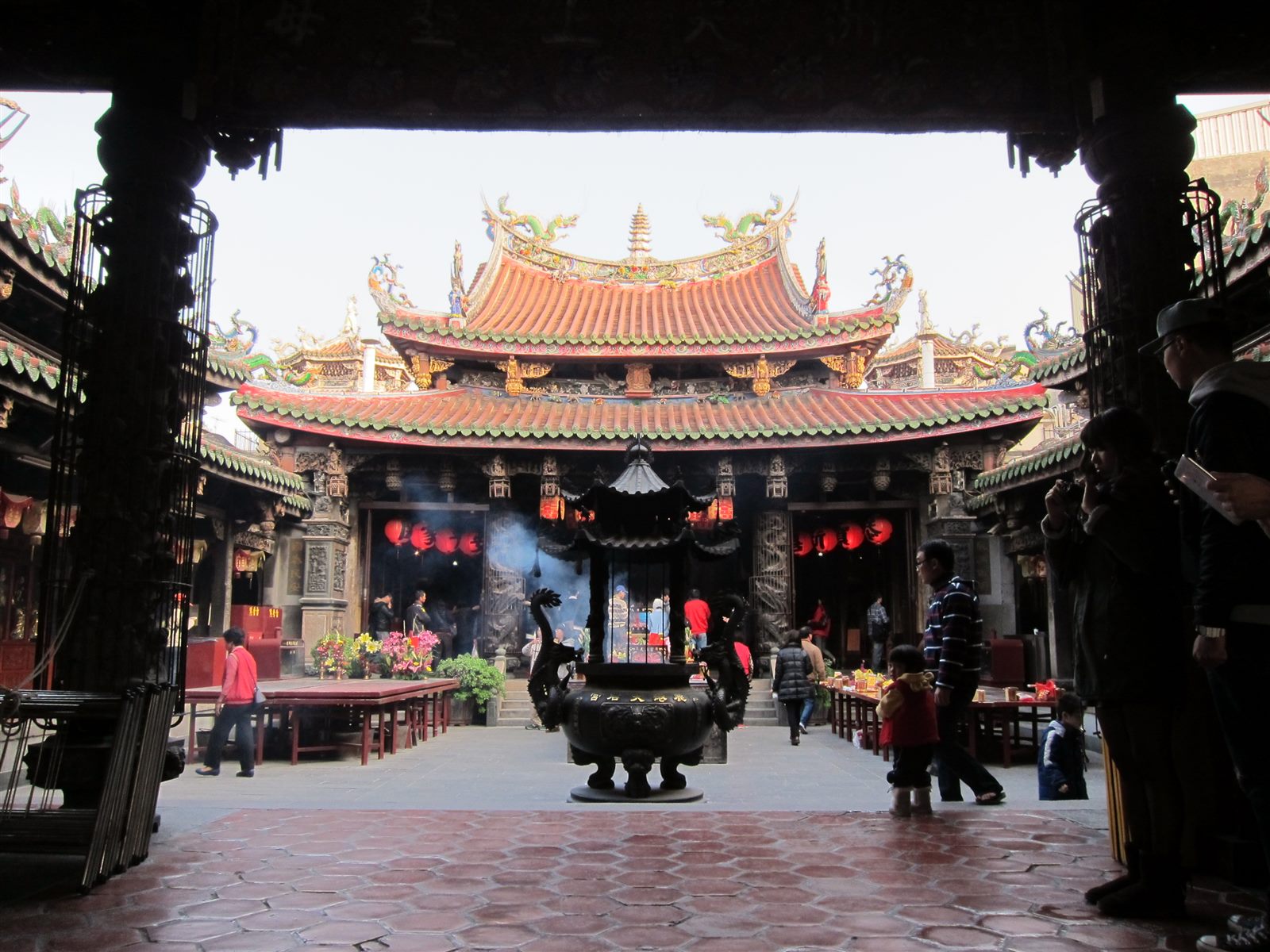 Taiwan temple roofline with colourful glazed dragon ornaments against blue sky