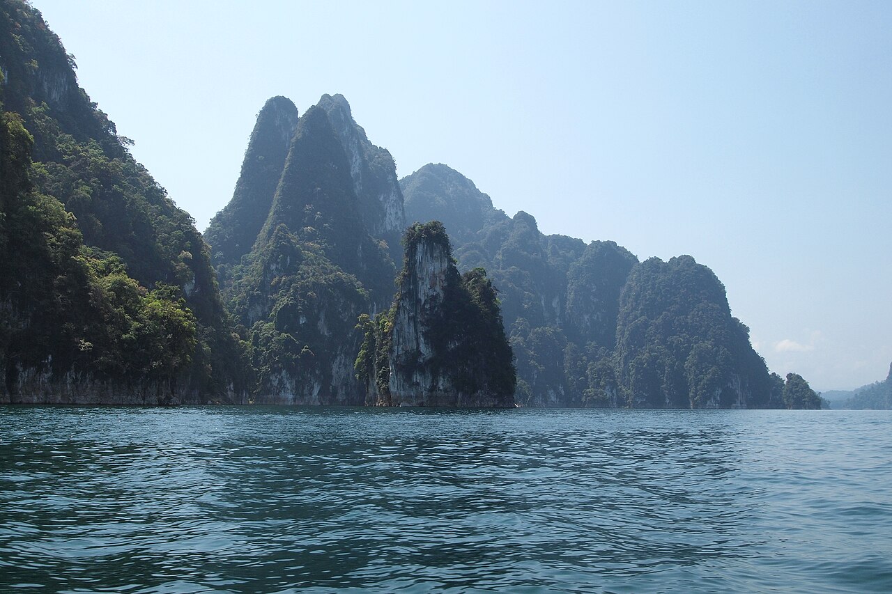 Cheow Lan Lake in Khao Sok National Park — rainforest-covered limestone karsts rising from still emerald-green water