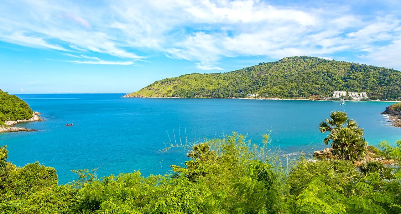 Windmill Viewpoint Phuket — a panorama of the island's southern bays, Ya Nui and Nai Harn beaches with Promthep Cape reaching into the sea