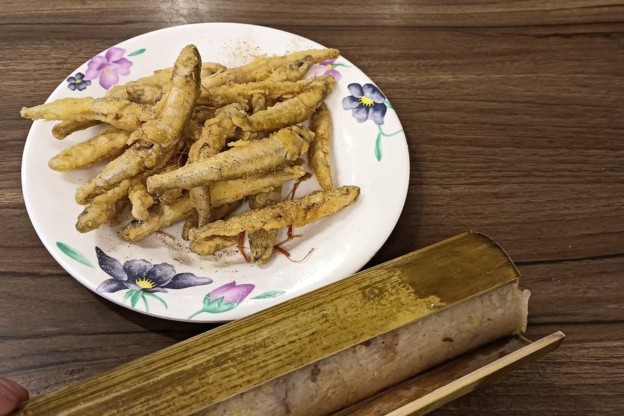 Bamboo-tube rice and fried river fish, traditional Atayal food from Wulai Old Street, Taiwan