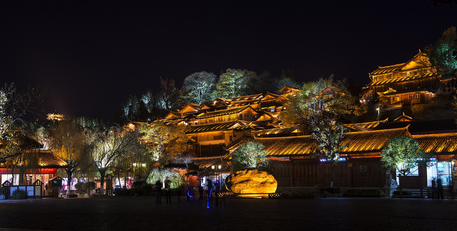 Dayan Old Town at night, tiered Naxi rooftops climbing Lion Hill in Lijiang — China