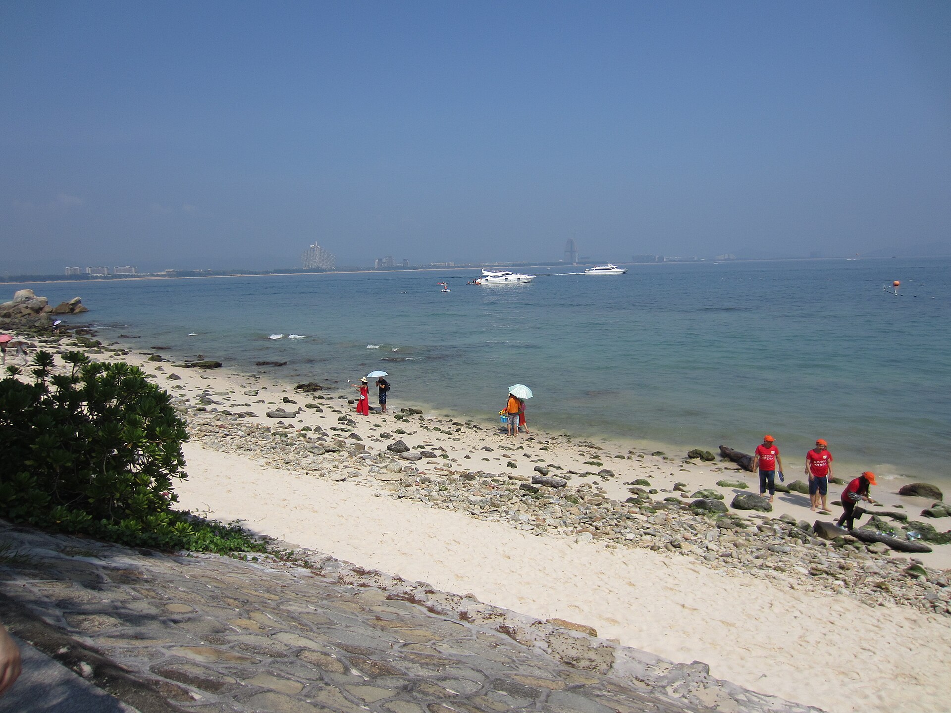Haitang Bay (海棠湾), where the resort sits — the long sandy beach on Sanya's northeast coast, next to the CDF Duty-Free Mall (a photo of the bay, not the resort building)