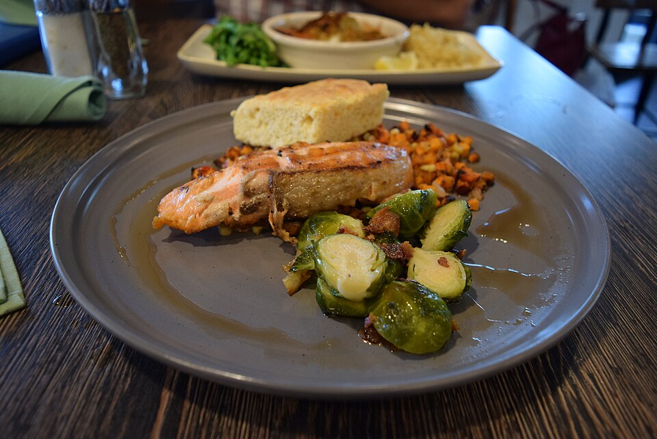 Maple-glazed grilled salmon plated with vegetables