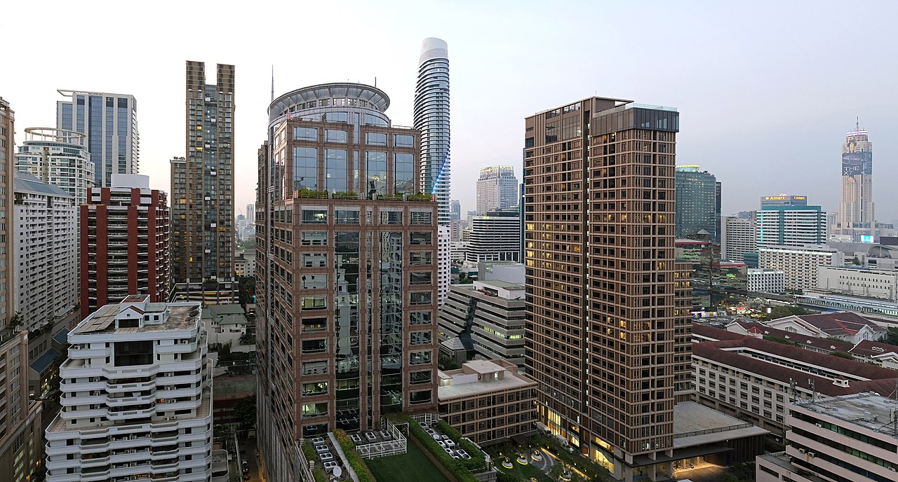 Bangkok towers in the soft light just before sunset, seen from a rooftop bar in the Langsuan area, before the city lights come on