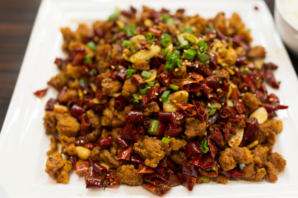 Laziji — crisp bite-sized fried chicken hidden under a huge heap of dried red chillies, scattered with sesame seeds and spring onion