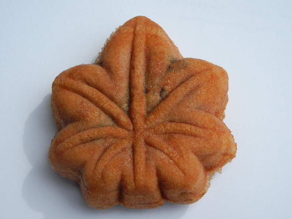 Momiji manju — a golden-brown maple-leaf-shaped Japanese cake, lightly crisp on the outside with a soft interior, on a white background