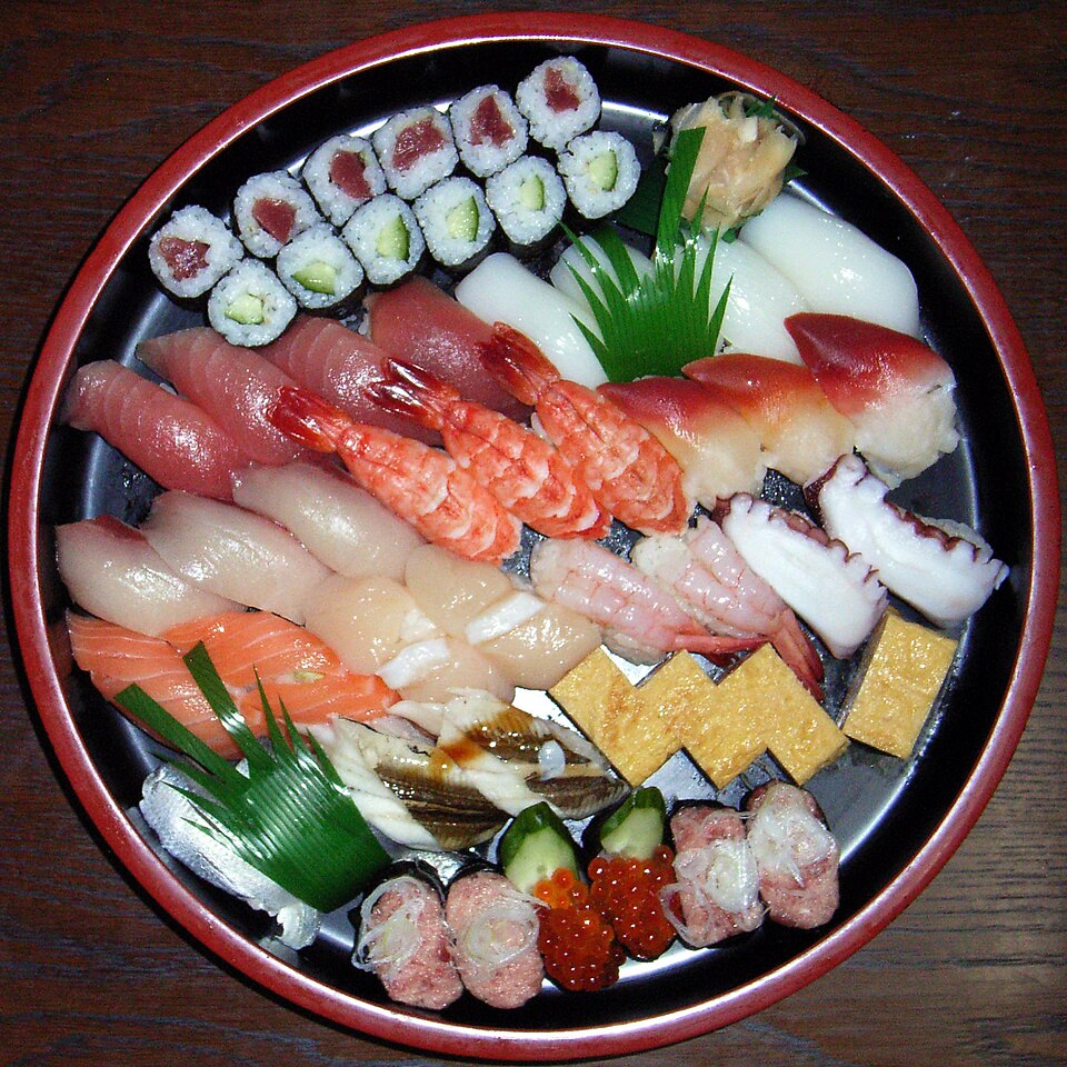 Sushi and sashimi beautifully arranged on a wooden board