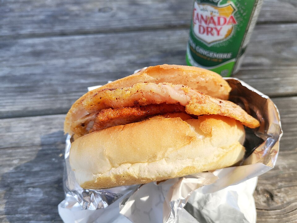 Peameal bacon sandwich with cornmeal-crusted bacon in a bun