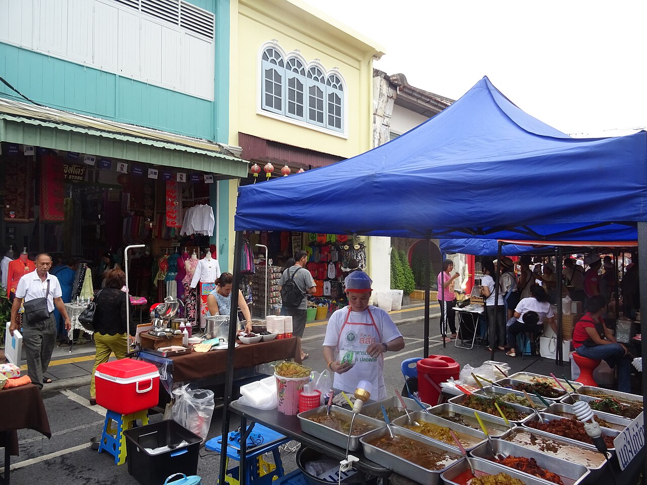 A street market on Thalang Road in Phuket Old Town, with food stalls and fresh produce among Sino-Portuguese shophouses, the kind of market walk many cooking classes do before the cooking starts