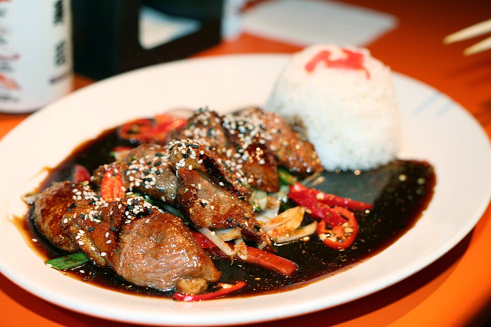 Teriyaki chicken in a thick glaze served with rice and cabbage