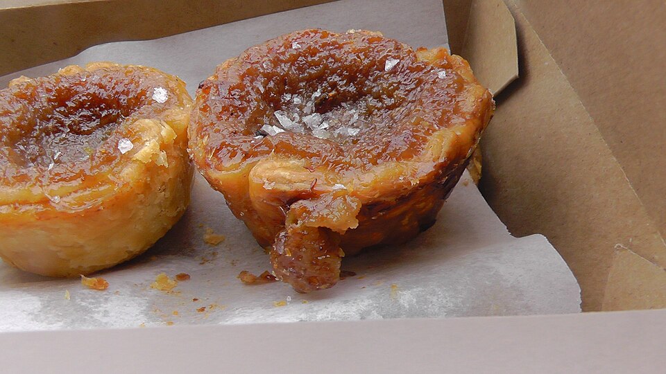 Butter tart with golden-brown buttery sugar filling in a crisp pastry shell