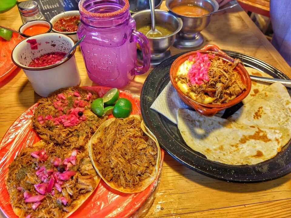Cochinita pibil tacos with red roast pork and pickled onion