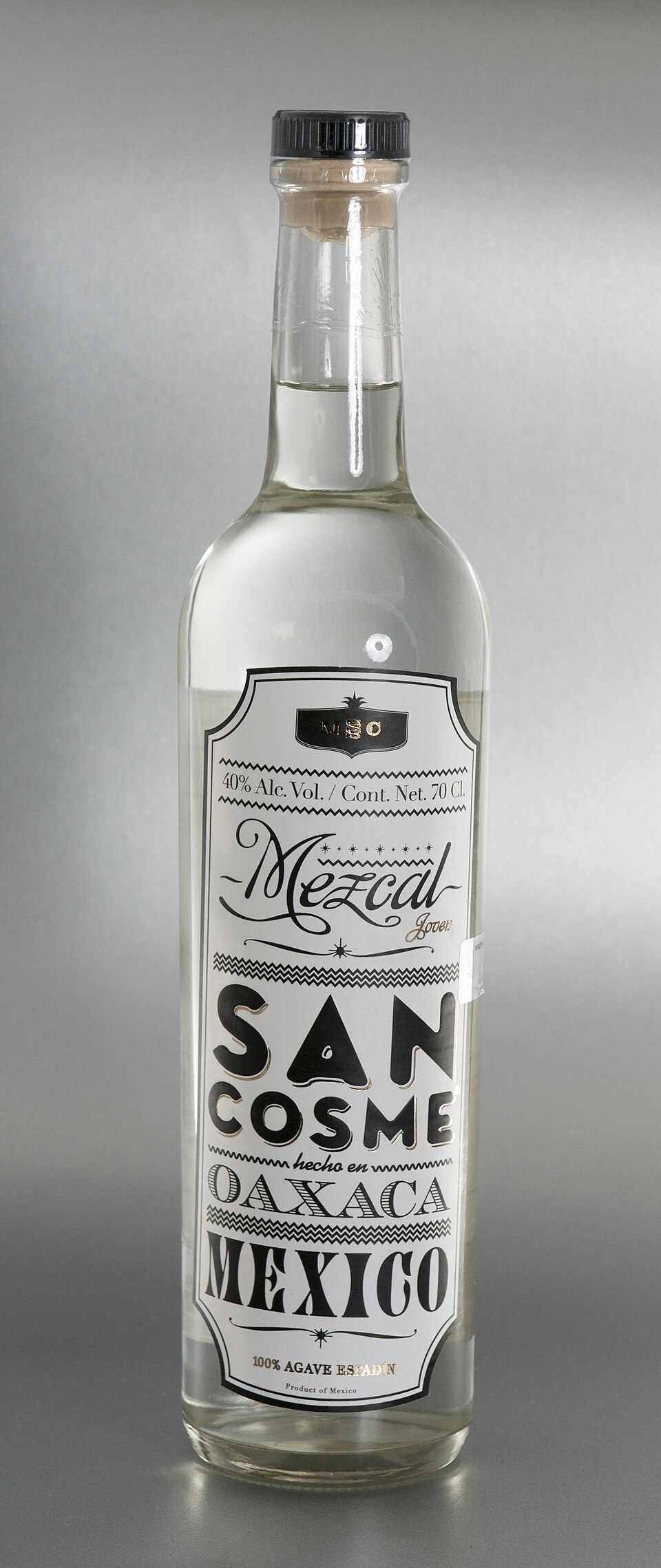 Mezcal in a small glass with orange and worm salt