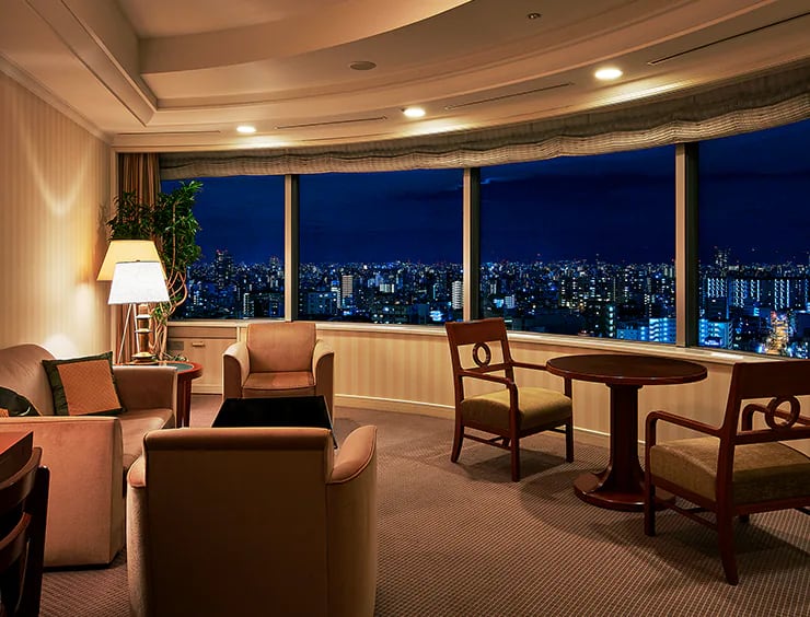 Imperial Floor lounge with curved floor-to-ceiling windows over the Osaka skyline at night