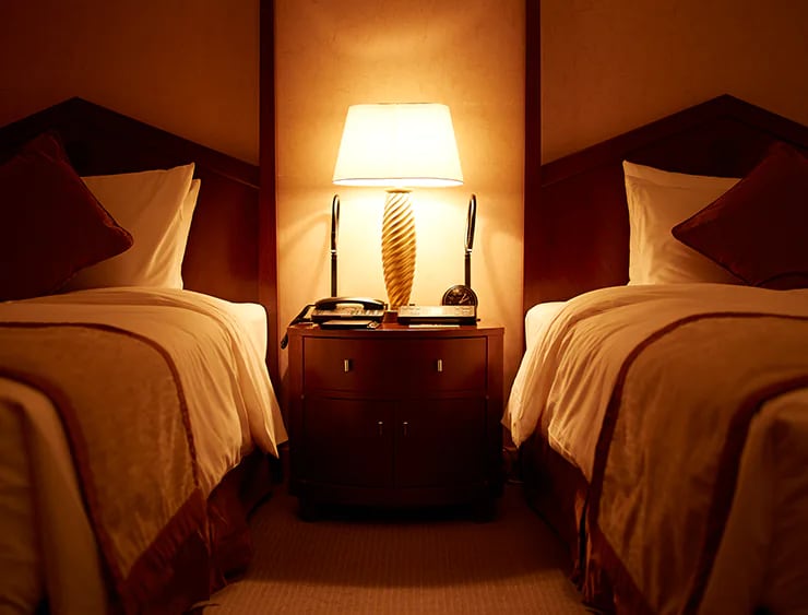 Classic warm-toned twin room with the hotel's signature lamp at Imperial Hotel Osaka