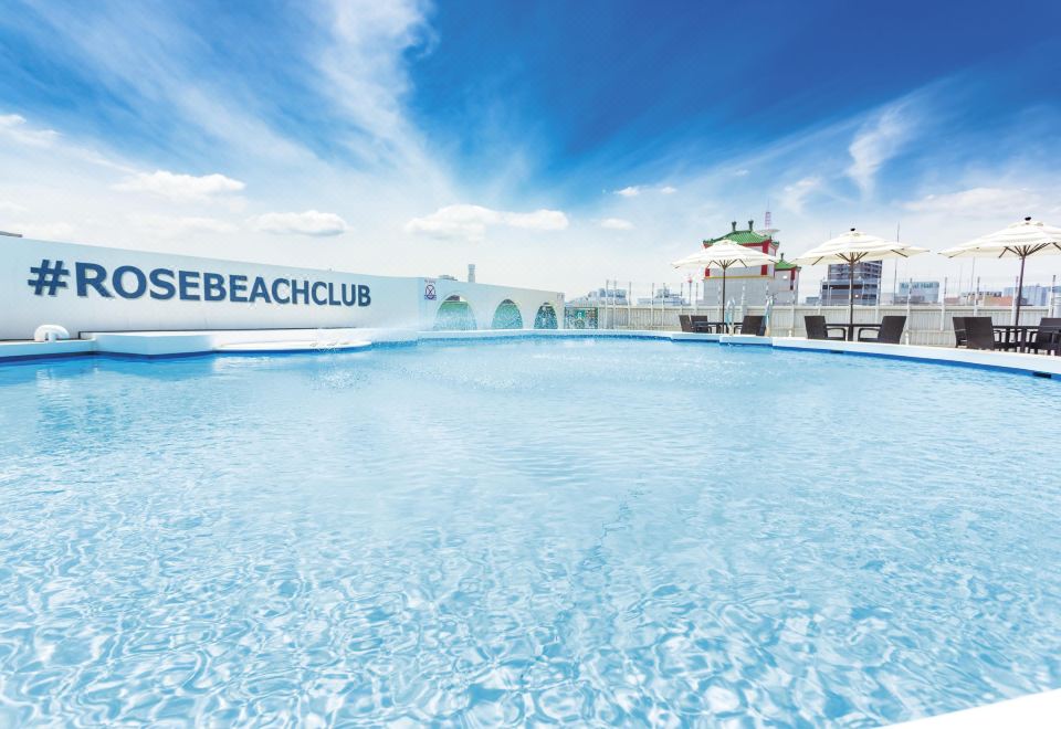 Rose Beach Club rooftop pool at Rose Hotel Yokohama overlooking Chinatown pagoda rooftops