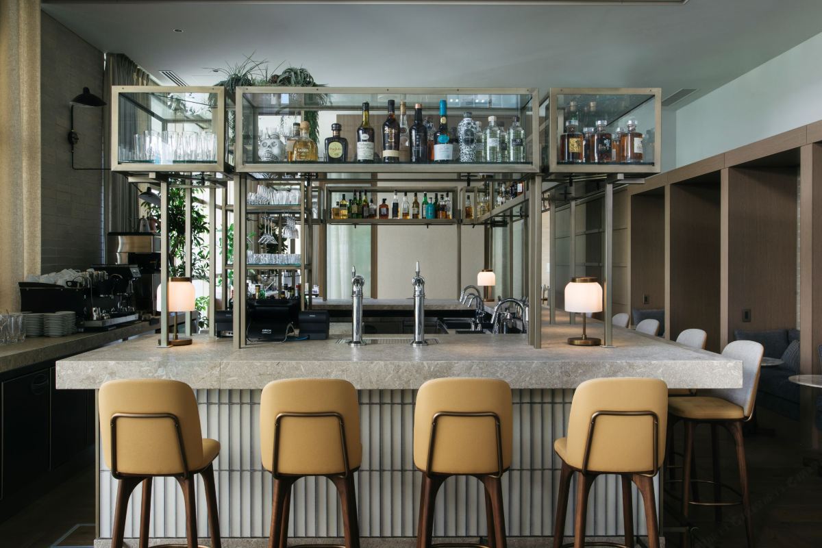 The UPSTAIRS bar at Zentis Osaka — a terrazzo counter under a brass-and-glass back-bar