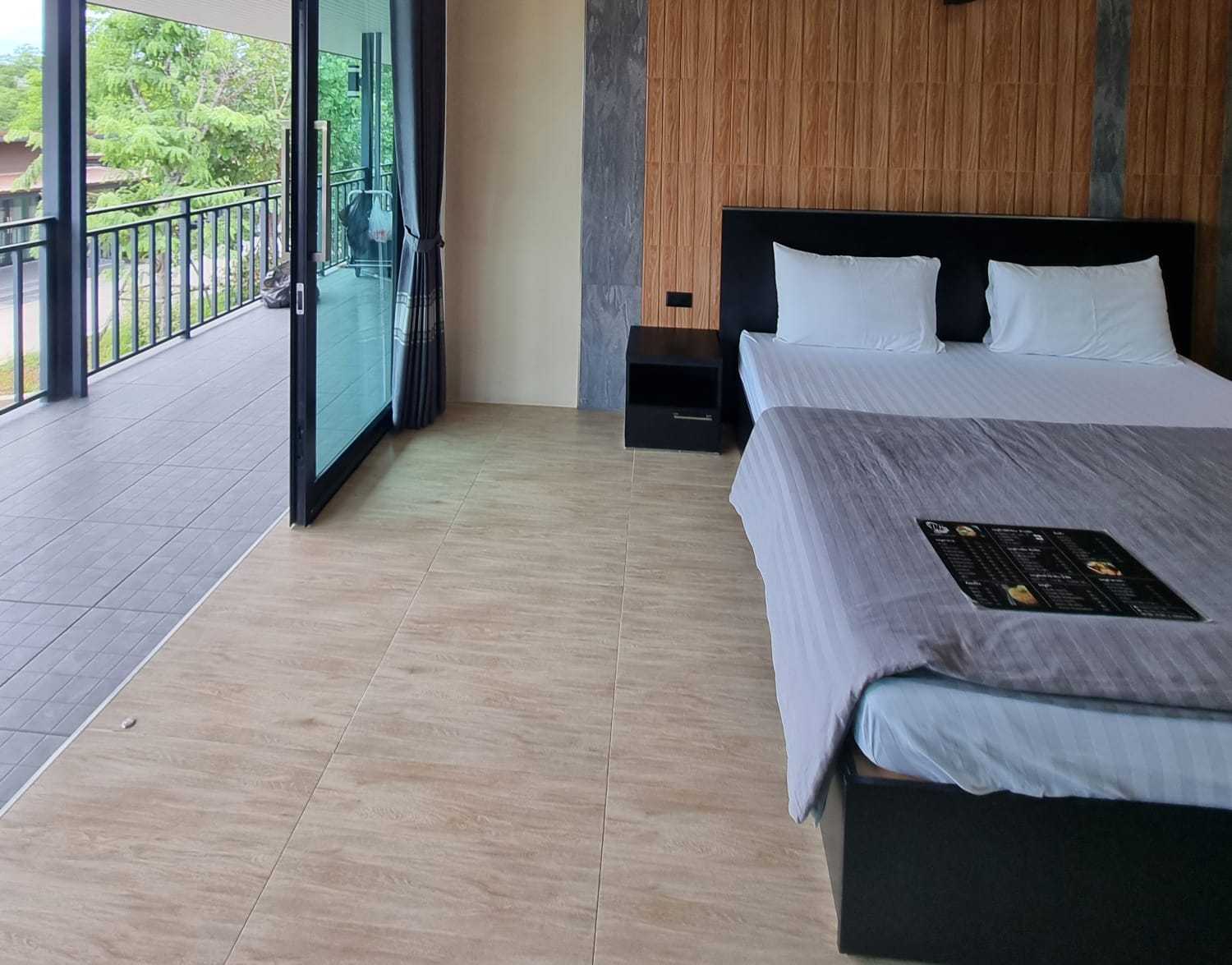 ห้องพักผนังไม้ระแนงพร้อมระเบียงส่วนตัวเปิดออกไปเจอต้นไม้ Ratchapruek DC Resort Angthong