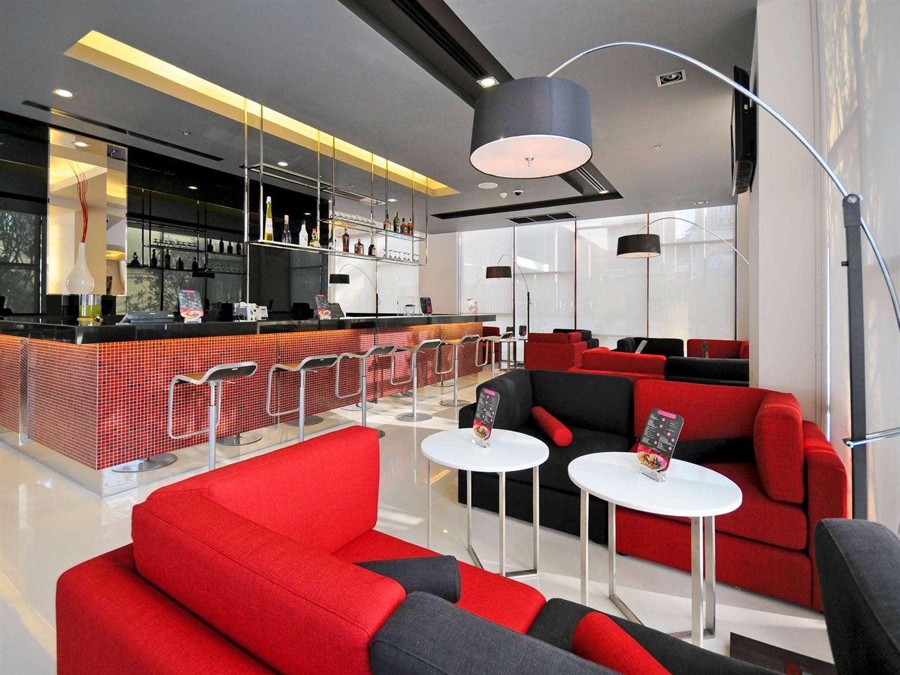Lobby bar at ibis Bangkok Sukhumvit 4 with the brand's signature red sofas