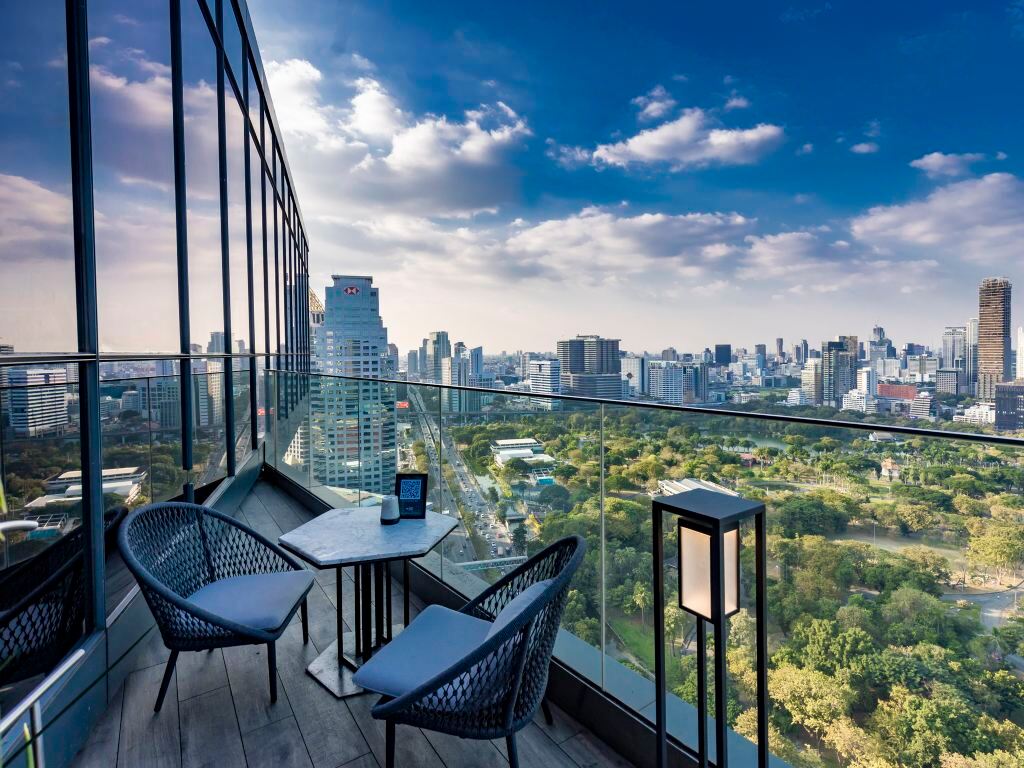 Guest-room balcony with views over Lumpini Park and the Sathorn financial district