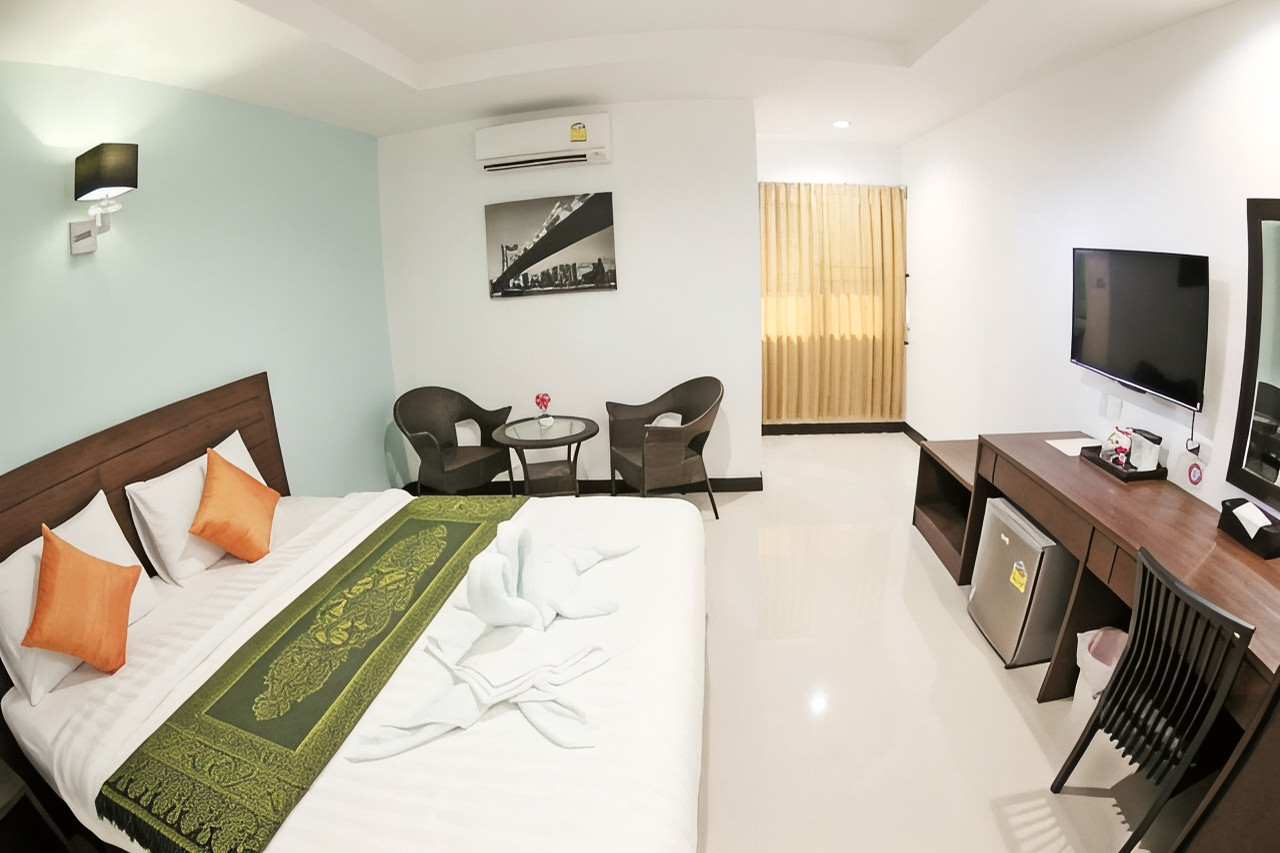 ห้องพัก BK Place Hotel เตียงใหญ่ มีโต๊ะทำงาน ตู้เย็น และทีวี