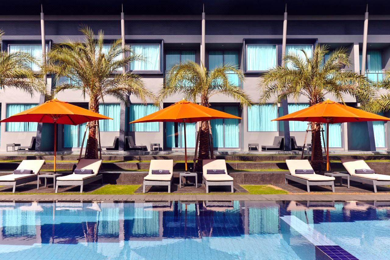 Outdoor pool with orange parasols at Amari Buriram United