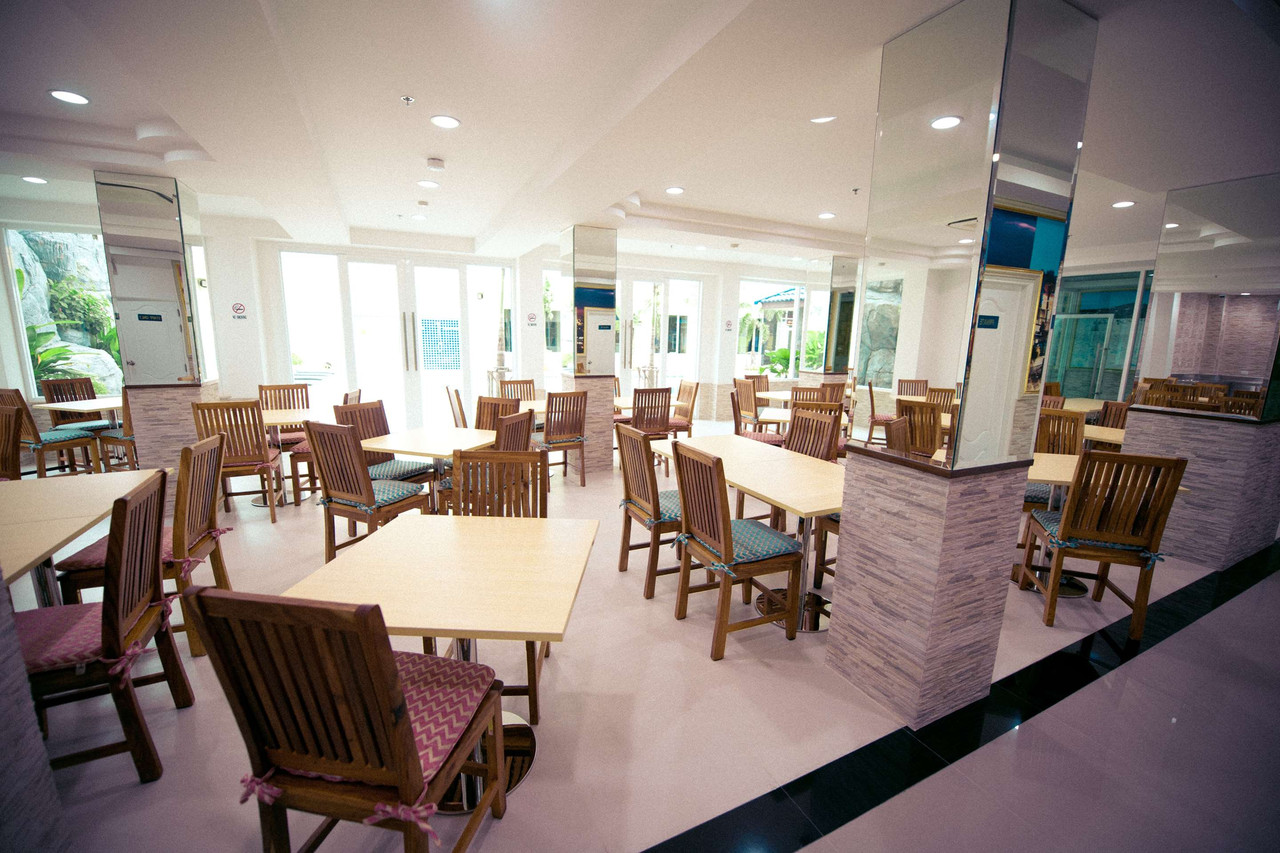 Chic Restaurant interior with bright dining hall and wooden breakfast tables