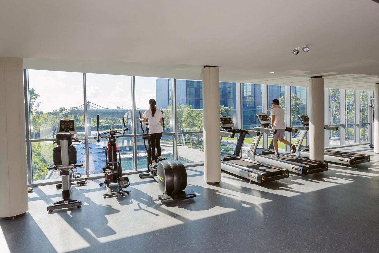 24-hour fitness centre with floor-to-ceiling windows overlooking the pool