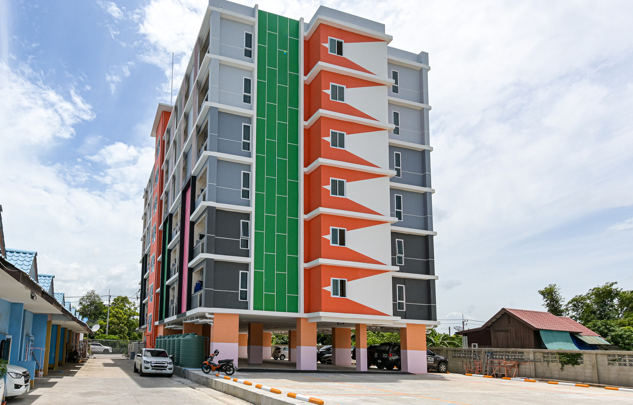 The Wish Hotel Chachoengsao building, green-and-orange new build with ground-floor parking