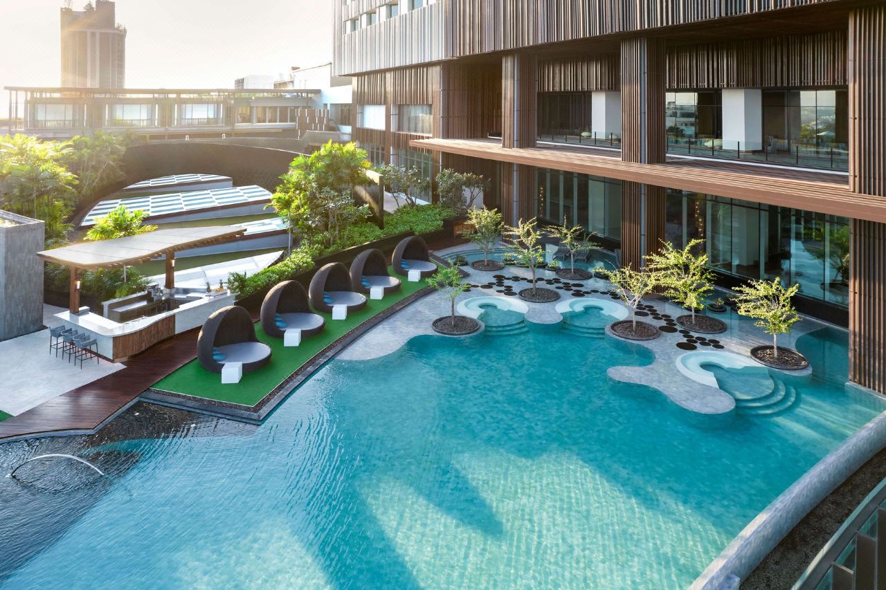 16th-floor infinity pool with egg-shaped pod loungers at the water's edge