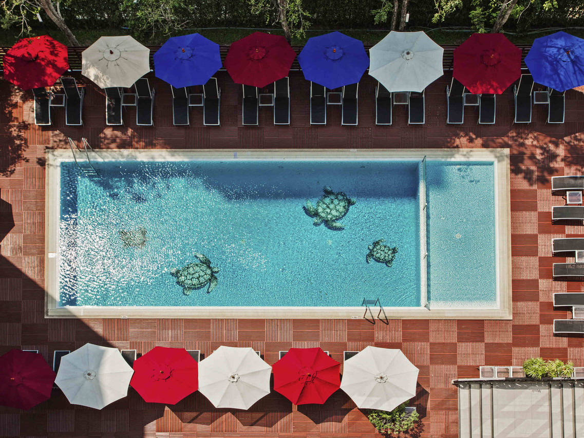 Aerial view of the outdoor pool with red, blue and white umbrellas