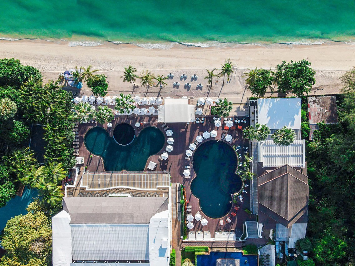 Aerial view of the two free-form pools on the sand at Pullman Pattaya Hotel G, Wongamat Beach