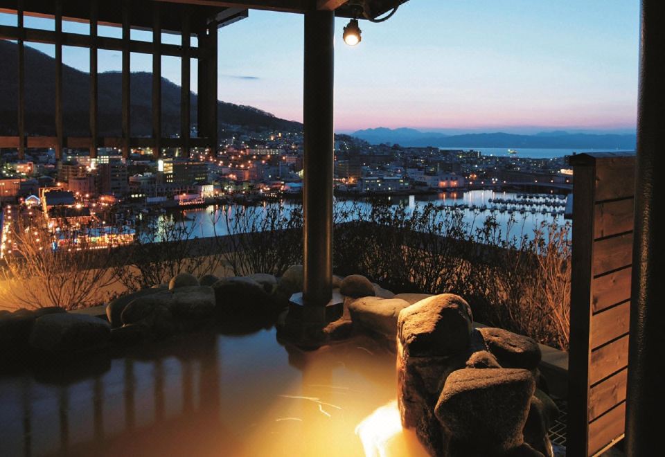 La Vista Hakodate Bay rooftop outdoor onsen (rotenburo) with panoramic bay and city view at dusk