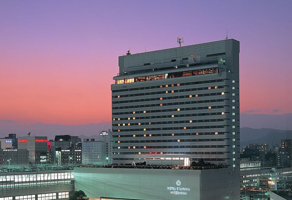 Hotel Granvia Hiroshima tower at sunset, the lit-up building directly above Hiroshima Station