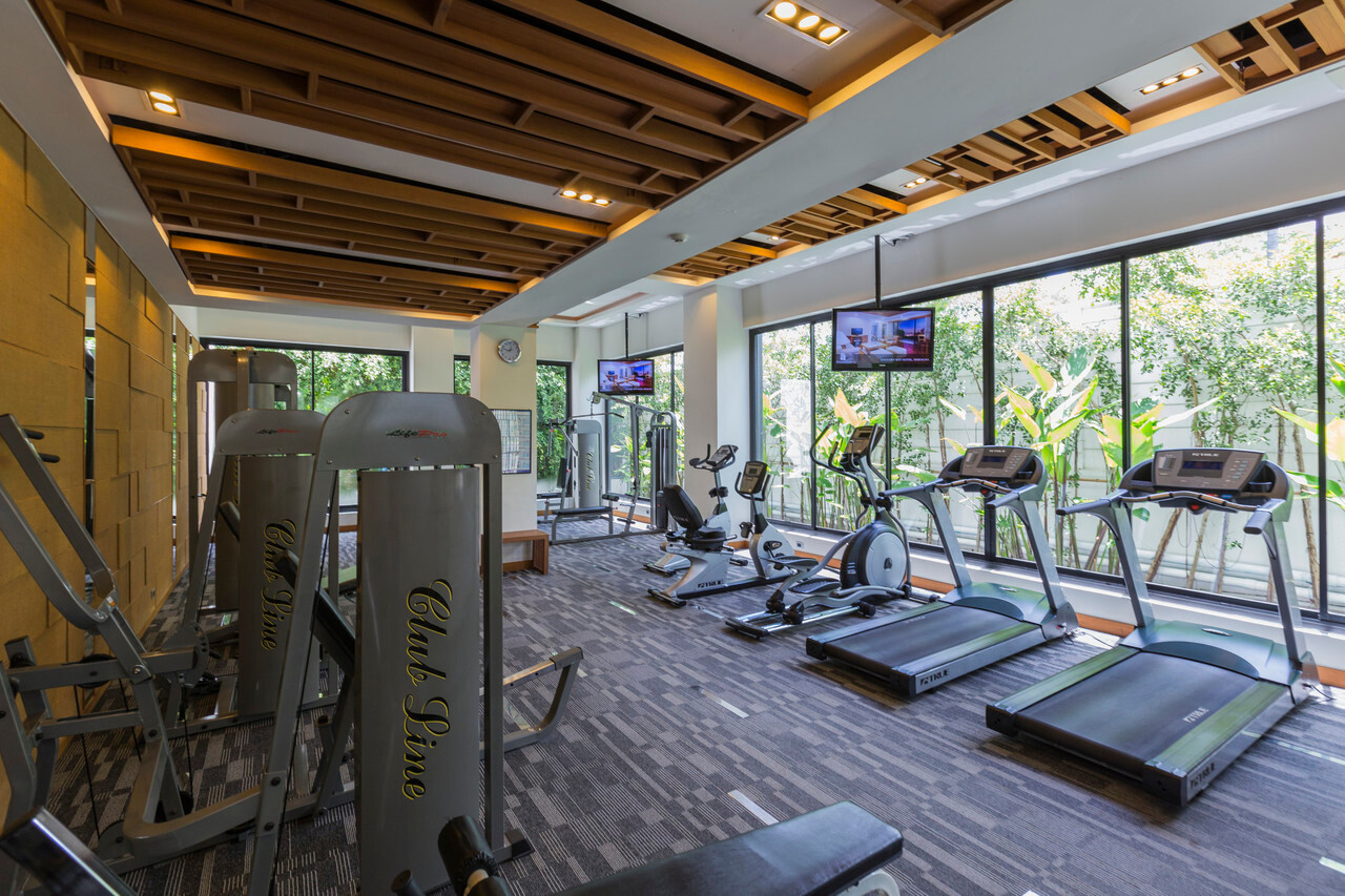 Fitness centre with floor-to-ceiling garden windows at Cape Nidhra Hua Hin