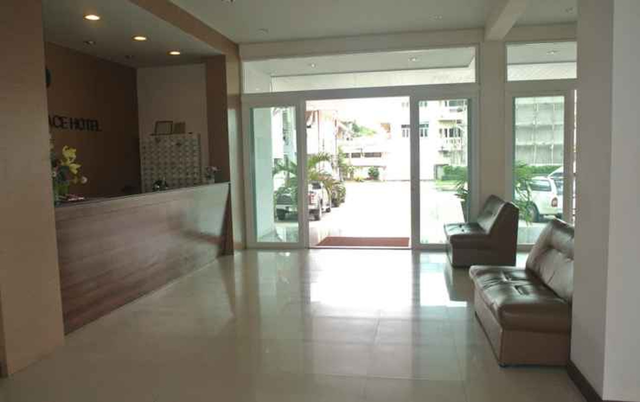Phaiboon Place Hotel lobby and reception with the hotel name on the wall