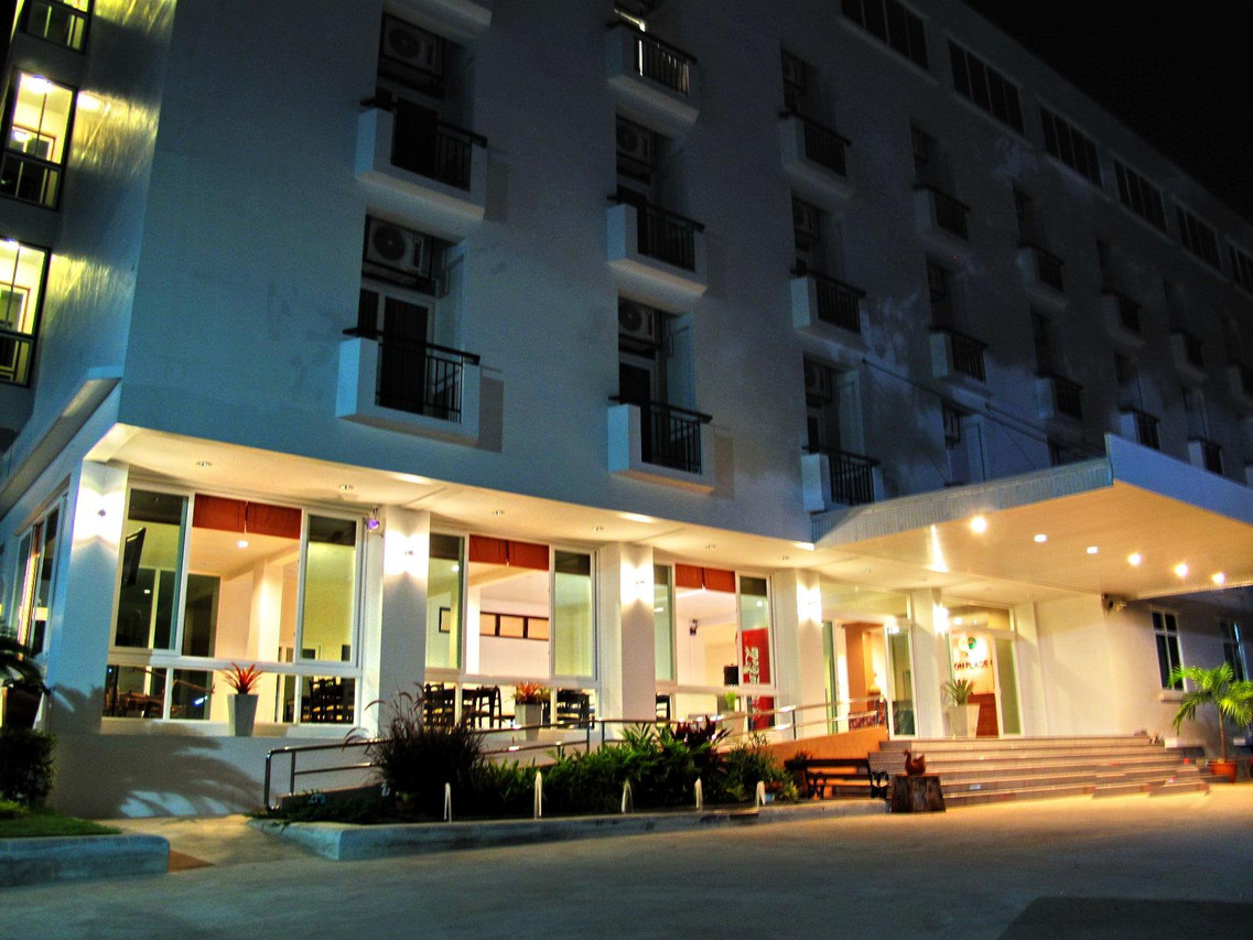 Phaiboon Place Hotel white building at night with a lit entrance