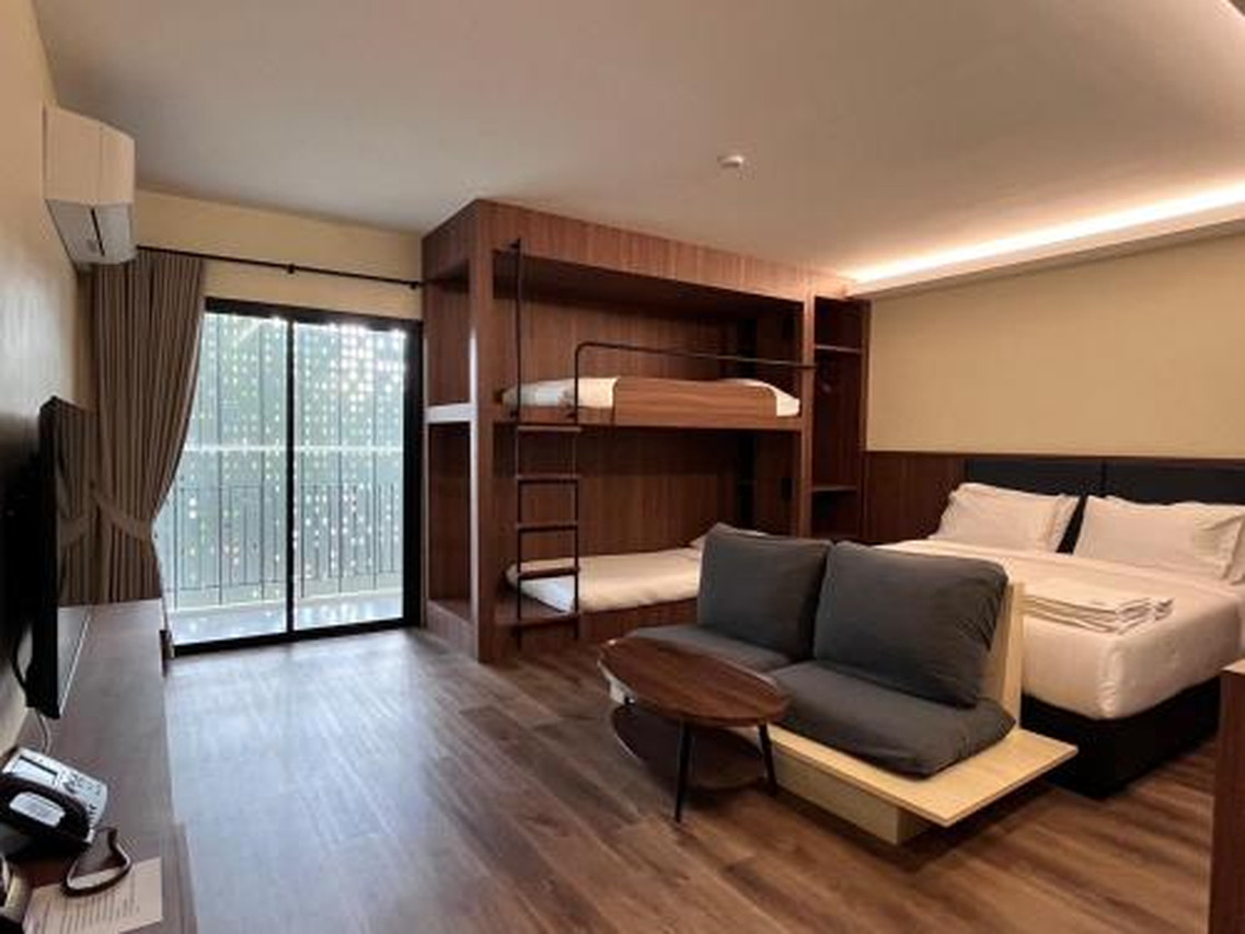 J2 Hotel Family Suite with a king bed, bunk bed, sofa and balcony