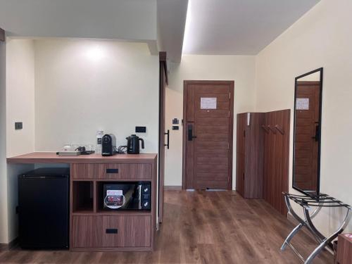 Minibar, microwave and luggage rack area inside a J2 Hotel room