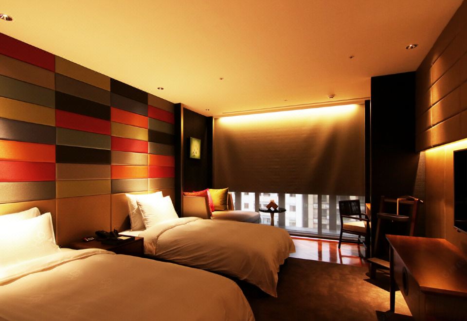 H2O Hotel twin guest room with colourful upholstered headboard wall and warm lifestyle lighting