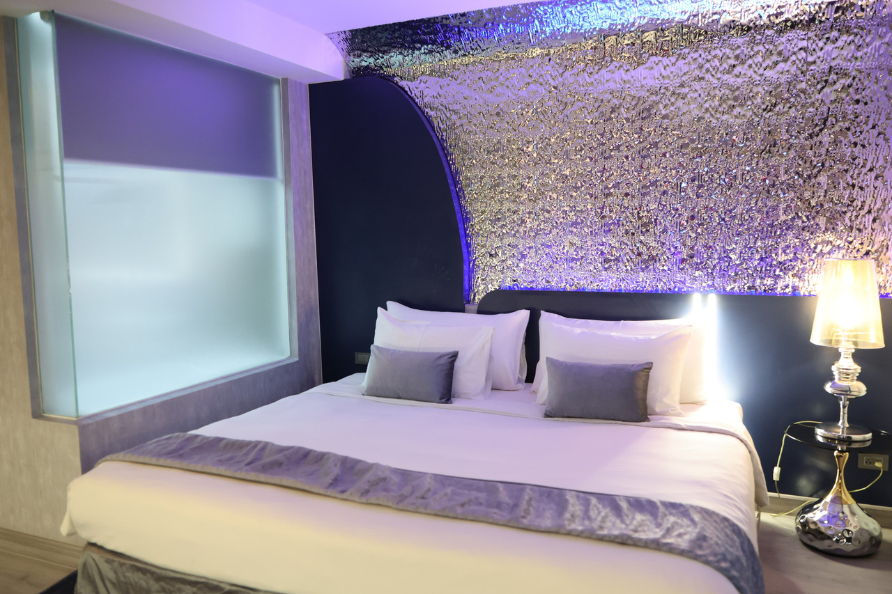 Guest room with a shimmering ice-themed headboard and a large bed