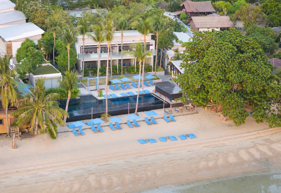 Aerial view of The Coast Resort Koh Phangan on Hat Rin Nai with infinity pool and beach loungers
