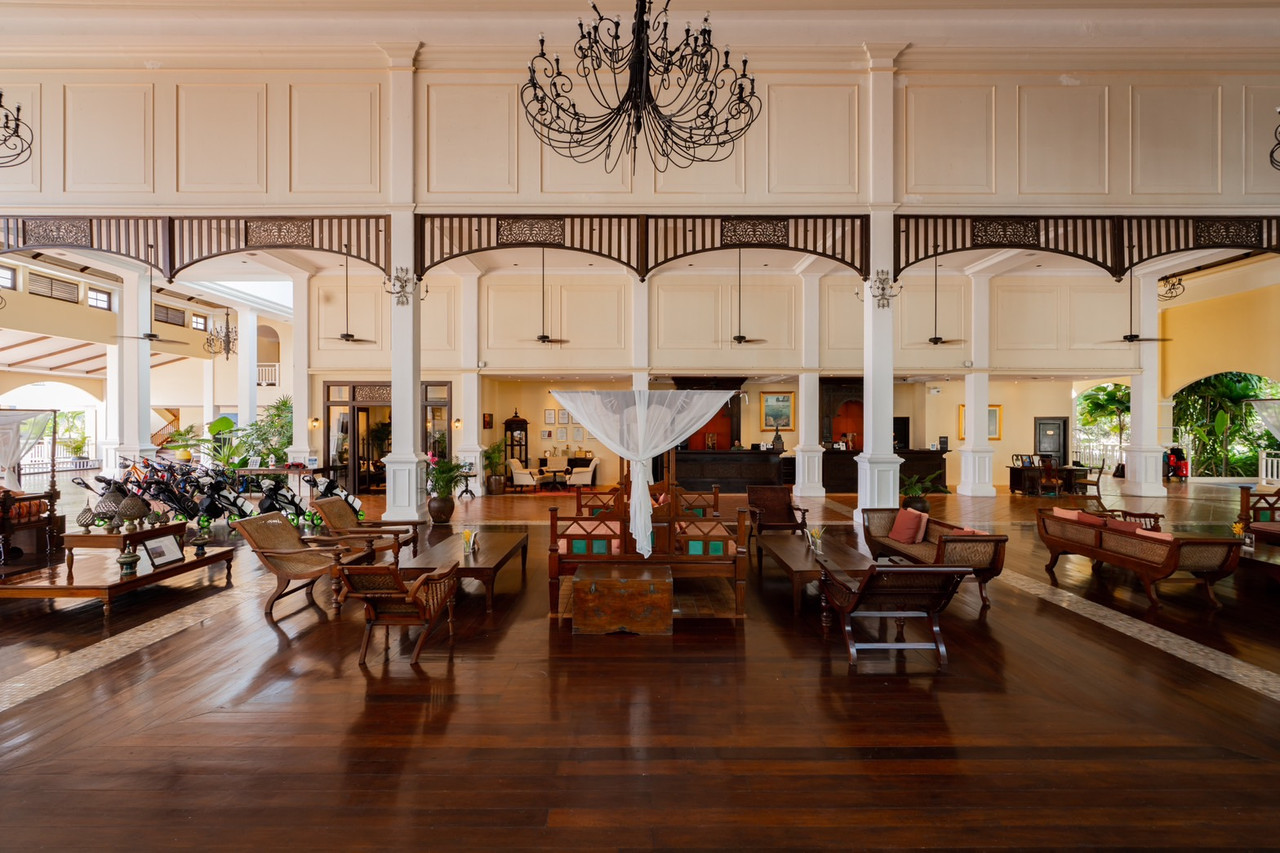 Thai-Victorian lobby with teak floors and chandeliers