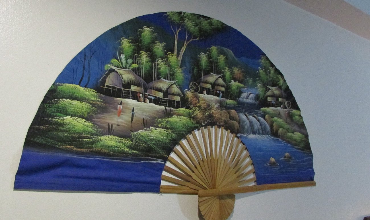 Hand-painted Thai fan with a Lanna village scene, in-room decor